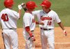 Arkansas Travelers first baseman Efren Navarro (16) is congratulated by teammates Brian Walker (40) and Ryan Mount after Navarro hit a two-run home run in the second inning of Monday’s game against Corpus Christi at Dickey-Stephens Park in North Little Rock. The Travelers won 4-3.