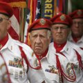 George Brannon, center, prepares to post the colors with other members of the VFW Honor Guard during...