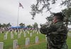 Greg Squirrel of Farmington plays taps Monday during a Memorial Day service at Fayetteville National Cemetery. Several hundred people attended the annual service.
