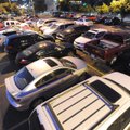 Automobiles fill the parking lot west of the Walton Arts Center on Thursday on West Dickson Street i...