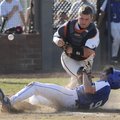 Rogers Heritage catcher Spanky Purdy tries to tag out Rogers High’s Alex Shelor on May 6 at Veterans...