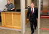 Benton County Judge Dave Bisbee passes through a metal detector Tuesday on his way to court in Bentonville. Bisbee was there to watch jury selection for his trial on four misdemeanor charges.
