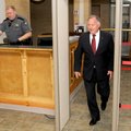 Benton County Judge Dave Bisbee passes through a metal detector Tuesday on his way to court in Bento...