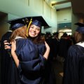 Victoria Lane DeJarnatte, center, gets a hug Tuesday from fellow Haas Hall Academy graduating senior...