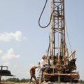 Mark Grantham, right, and John Hale, with Grantham Drilling Company of Poteau, Okla., drill Tuesday ...