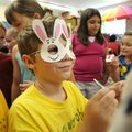 Carlton Wilcox, 7, wears a bunny mask Wednesday while shopping at a makeshift store at Greenland Ele...