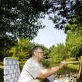 Gloria Pendry of Farmington paints an oil on canvas scene Wednesday of the pond along Cedar Brooke L...