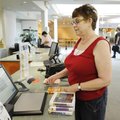 Sue Rea of Springdale checks out audio books from the Springdale Public Library on Friday to listen ...