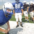 Rogers High linebackers, including Blake Neil, left, go through drills at spring practice Wednesday.