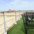 Members of the Physicians’ Specialty Hospital Wildcats baseball team take batting practice in the ba...