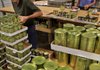 Paul Langston (left) and Lloyd Koby are among volunteers from Christ of the Hills United Methodist Church in Hot Springs Village who sorted and labeled more than 250 types of canned vegetables Thursday at the Arkansas Rice Depot, which was reporting a shortage of meat donations for food banks statewide.