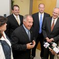 County Judge Dave Bisbee, center, talks with reporters Friday about his acquittal on two of three mi...