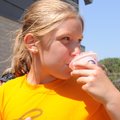FIELD DAY TREAT - Ellie Podojil, 8, cools off Friday with a snow cone at Central Park Elementary Sch...
