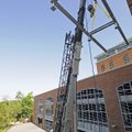 A bracket for solar panels is installed Friday at the Fayetteville Public Library. Within the next m...