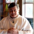 The Rev. Joe Marconi stands to greets worshippers before Mass at St. Thomas Aquinas on May 30.