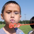 SUMMER FUN - Michael Hollowell, 6, gets a good bubble started Friday at Jones Elementary School in R...