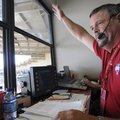 Arkansas public address announcer Pat Kelly “Calls the Hogs” with along with fans Friday before the ...