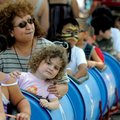 Edith Ellington rides a train Saturday with her granddaughter Teagan Haulk, 7, during the Internatio...
