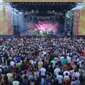 Fans cheer on the band Umphrey’s McGee on Friday night, playing the main stage of the Wakarusa music...