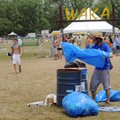 Jeremy Speck of Memphis empties trash Saturday at the Wakarusa music festival. Speck gained admissio...
