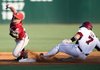Arkansas' Zack Cox stretches a hit into a double as Washington State second-baseman Cody Bartlett tries to field the throw from the outfield during the Fayetteville Regional Sunday, June 6