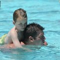 Tyler Moore, 5, of Springdale rides on the back of his father, Michael Moore, while spending Sunday ...