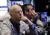 Trader Philip O'Rourke, left, works on the floor of the New York Stock Exchange Monday, June 7, 2010.
