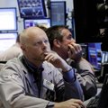Trader Philip O'Rourke, left, works on the floor of the New York Stock Exchange Monday, June 7, 2010...