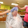 Grace Hill Elementary School librarian Jeanne Trueg hunkers while Jose Monroy, and Yasmin Fiallos, b...