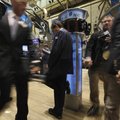 In this June 7, 2010 photo, a trader leans on a phone post as he works on the floor of the New York ...