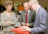 Laura Lee Brown, from left, Mayor Bob McCaslin and Steve Wilson from 21c Museum Hotels talk Tuesday following a news conference at Compton Gardens in Bentonville. Wilson announced plans for a 21c Museum Hotel near the northeast corner of Bentonville square. The 4-foot-tall red plastic penguin is part of a moving exhibit at the 21c Museum Hotel in Louisville, Ky.