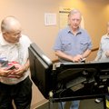 Polling sheriff Wayne Schoeller assists Richard and Jane Scates of Bentonville on Tuesday at the Dis...
