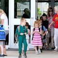 Retired teacher Mary Mae Jones, right, says goodbye Tuesday to students on the last day of school at...