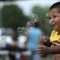 Toddler Alexander Alvarez plays with bubbles Tuesday at the Rogers Community-School Recreation Assoc...