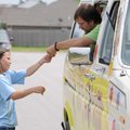 Tristen Tucker, 12, of Bartlesville, Okla., buys a cold treat Wednesday from Cody Toye of Confetti I...
