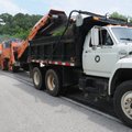 Workers with the Arkansas State Highway and Transportation Department mill the southbound lane of U....