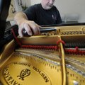 Greg Lynch of Tulsa, Okla., tunes a Steinway & Sons piano Wednesday at the KUAF studio in Fayettevil...