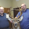 Ray Reynolds, left, and Chris Reynolds show a buck Chris killed in 2007. The father and son each sco...