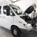 Diesel technician Hector Ramirez, right, speaks with Connie and Paul Corhn about their Dodge Sprinte...