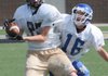 Bentonville’s Luke Crenshaw catches a pass Thursday while being covered by Mountain Home’s Hunter Thorpe at Tiger Stadium in Bentonville. Bentonville hosted Mountain Home, Shiloh Christian and Jenks, Okla., for a football camp.
