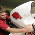 SOLAR SPLASH - Matt Bell, a member of the University of Arkansas solar boat team, attaches a scoop T...
