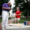 Monroe Glaser of Bella Vista signs a petition for Secure Arkansas at the Bentonville square on Thurs...