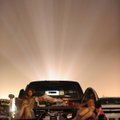 A family watches “Prince of Persia: The Sands Of Time” from the bed of their pickup truck at the 112...
