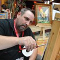 Matt Coburn, of Benton paints Friday during the 51st annual Poultry Festival presented by The Poultr...
