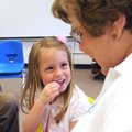 LIFE’S LEGACY - Kindergartner Paige Kelly listens Friday while her grandmother Pat Hane reads from t...