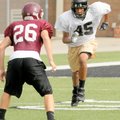Bentonville receiver Desmond Smith sprints downfield against Jenks, Okla., during a football camp Fr...