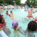 FLOAT FUN - University of Arkansas student and lifeguard Colby Smith, right, celebrates as Marley Hu...
