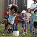 Skyyla McCaster, 7, of Pea Ridge rounds a turn while participating in stick horse barrel racing Thur...