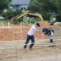Sloan Spain packs down dirt Wednesday at the site of construction for America’s Car-Mart’s 1866 E. R...