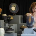 ON DISPLAY - Janie Sokol of Bella Vista examines the raku-fired pottery of Fayetteville artist Don N...